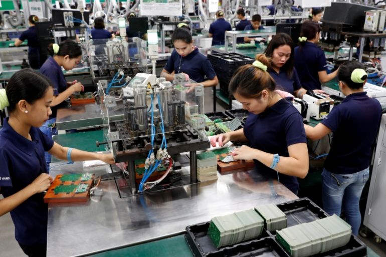 Filipinos work at the assembly line of Kinpo Electronics factory in Malvar