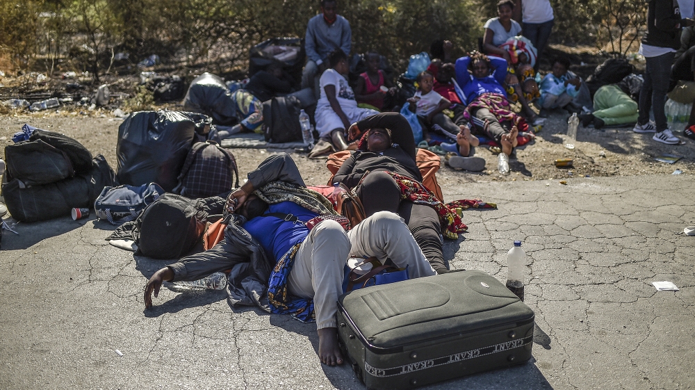 Migrants sleep on the ground outside camp of Moria on the island of Lesbos after a major fire broke out, on September 9, 2020. Thousands of asylum seekers on the Greek island of Lesbos fled for their 