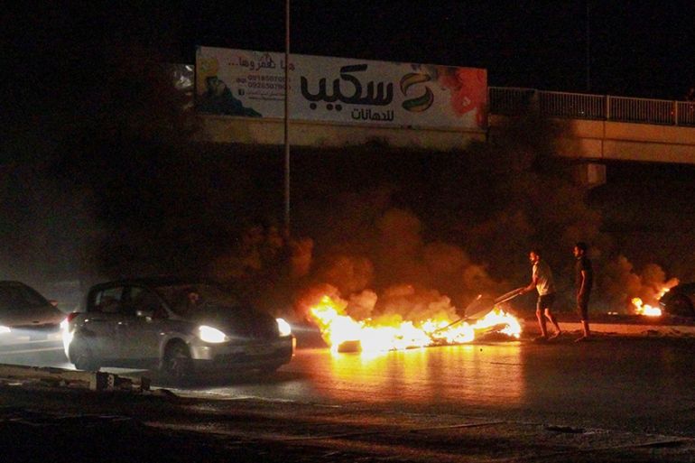 Libyan youth block a road with burning tyres in Libya''s eastern coastal city of Benghazi on September 12, 2020, as they protest the poor public services and living conditions. (Photo by Abdullah DOMA