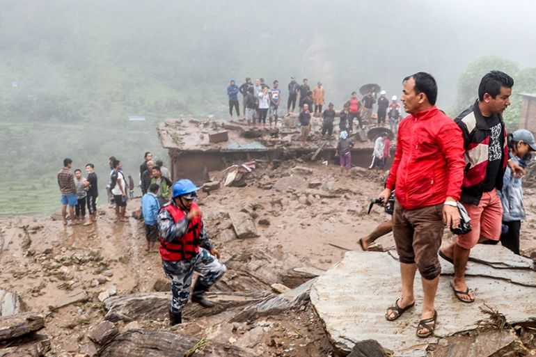 Rescue workers and residents gather for search at the scene of a landslide following heavy rains in Bahrabise municipality of Sindhupalchok district, some 90 kms northeast of Kathmandu on September 13