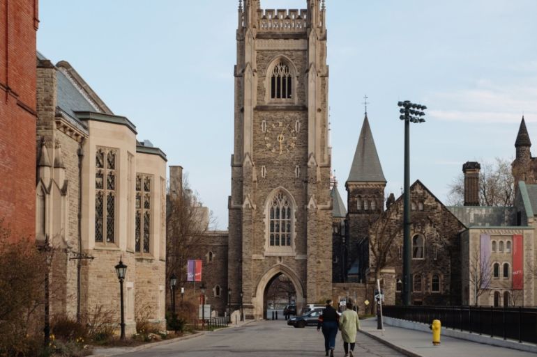Pedestrians walk through the University of Toronto campus in Toronto, Ontario, Canada, on Tuesday, April 28, 2020. It could be August before Ontario''s economy is fully back in business after the coron