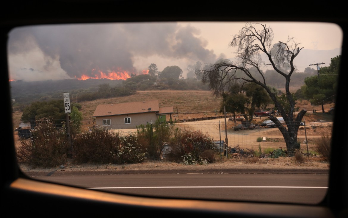A brush fire encroaches along Japatul Road during the Valley Fire in Jamul, California on September 6, 2020 - The Valley Fire in the Japatul Valley burned 4,000 acres overnight with no containment and