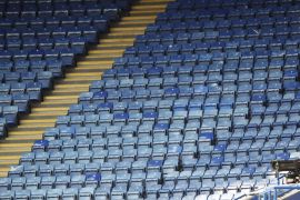 Soccer Football - Premier League - Leicester City v Brighton & Hove Albion - King Power Stadium, Leicester, Britain - June 23, 2020 A TV cameraman is seen with empty seats in the stands, as play resum