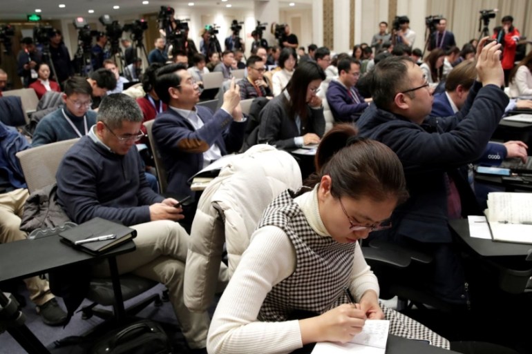 Journalists attend a news conference on the state of trade negotiations between China and U.S. in Beijing