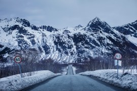 A snowy road and mountains in Norway