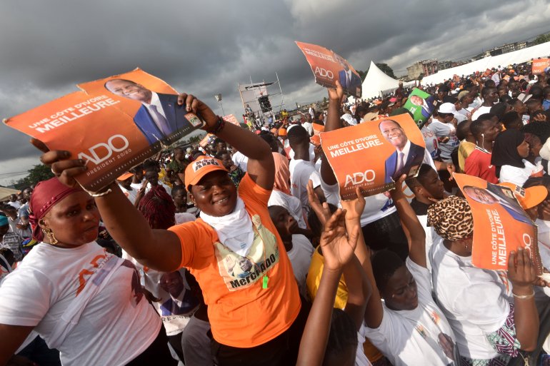 Supporters of incumbent President Alassane Ouattara take part in a campaign meeting in Abidjan ahead of the presidential election [Sia Kambou/AFP]