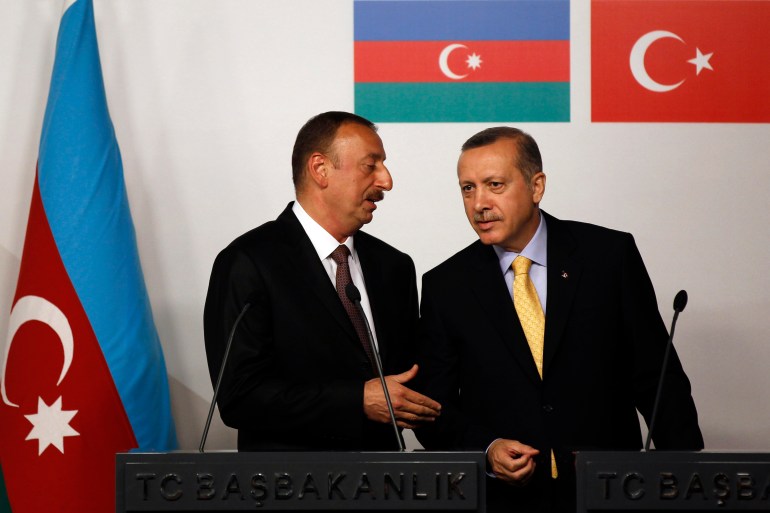Azerbaijan's President Ilham Aliyev (left) chats with Turkey's Prime Minister Recep Tayyip Erdogan during a news conference following a signing ceremony in Istanbul June 26, 2012 [File: Murad Sezer/Reuters]