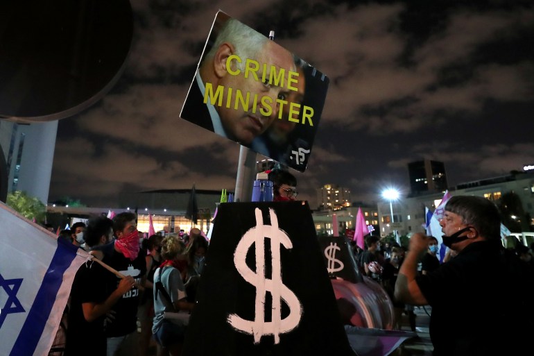 Signs are pictured during a protest against Israeli Prime Minister Benjamin Netanyahu's alleged corruption and the economic hardship stemming from the coronavirus disease (COVID-19) crisis, amid Israel's second nationwide lockdown, in Tel Aviv, Israel October 10, 2020. REUTERS/Ammar Awad