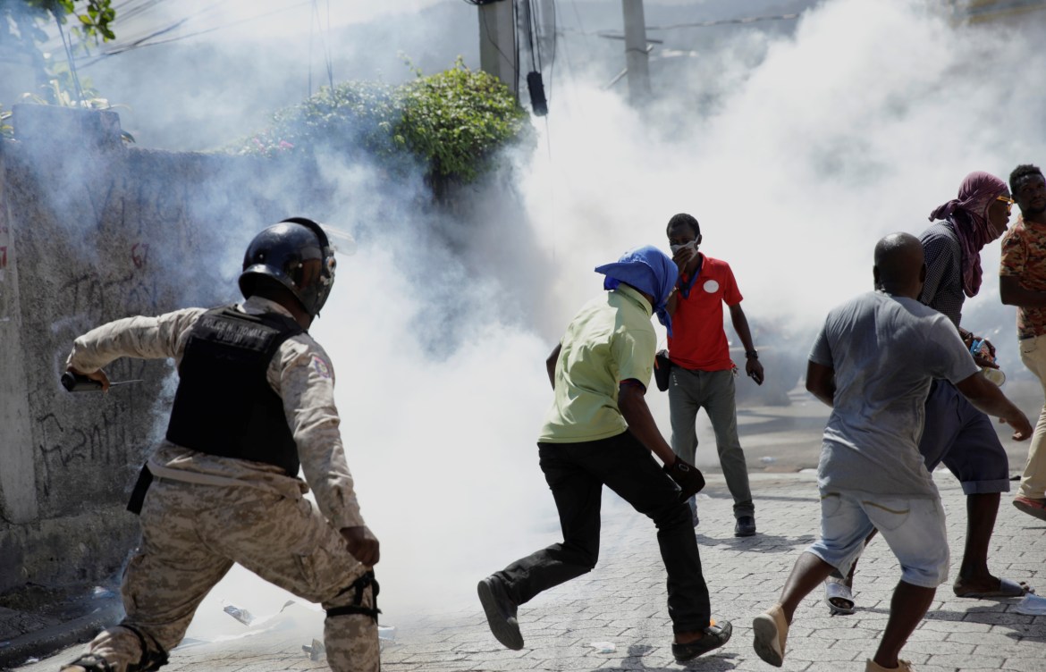 Haitian police fired rubber bullets and tear gas to disperse anti-government protesters. [Andres Martinez Casares/Reuters]