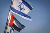 Israeli national flags fly alongside a United Arab Emirates national flag along the side of a road in Netanya, Israel, on Aug 17, 2020 [Kobi Wolf/Bloomberg]