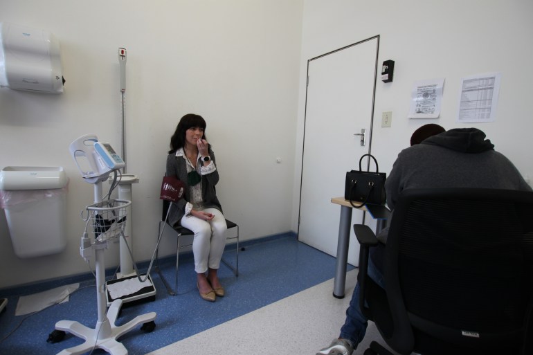 COVID-19 vaccine trial participant Robyn Porteous has her vitals checked [Garret Barnwell/Al Jazeera]