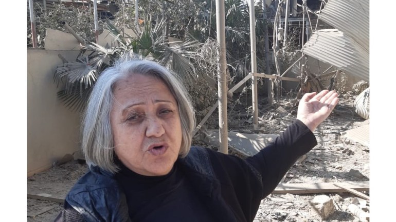 Sevil Aliyeva stands in front of the rubble of her house in Azerbaijan's second city of Ganja [Seymur Kazimov/Al Jazeera]