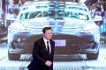 Tesla Inc CEO Elon Musk walks next to a screen showing an image of Tesla Model 3 car during an opening ceremony for Tesla China-made Model Y program in Shanghai, China
