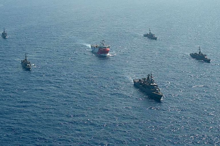 This handout photograph released by the Turkish Defence Ministry on August 12, 2020, shows Turkish seismic research vessel 'Oruc Reis' (C) as it is escorted by Turkish Naval ships in the Mediterranean Sea, off Antalya on August 10, 2020. - Greece on August 11, demanded that Turkey withdraw a research ship at the heart of their growing dispute over maritime rights and warned it would defend its sovereignty, calling for an emergency meeting of EU foreign ministers to resolve the crisis. Tensions were stoked August 10, when Ankara dispatched the research ship Oruc Reis accompanied by Turkish naval vessels off the Greek island of Kastellorizo in the eastern Mediterranean.