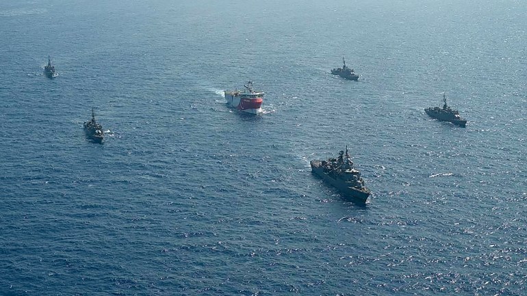 This handout photograph released by the Turkish Defense Ministry on August 12, 2020, shows Turkish seismic research vessel 'Oruc Reis' (C) as it is escorted by Turkish Naval ships in the Mediterranean Sea, off Antalya on August 10, 2020. - Greece on August 11, demanded that Turkey withdraw a research ship at the heart of their growing dispute over maritime rights and warned it would defend its sovereignty, calling for an emergency meeting of EU foreign ministers to resolve the crisis.  Tensions were stoked August 10, when Ankara dispatched the ship Oruc Reis accompanied by Turkish naval vessels off the Greek island of Kastellorizo ​​in the eastern Mediterranean. 