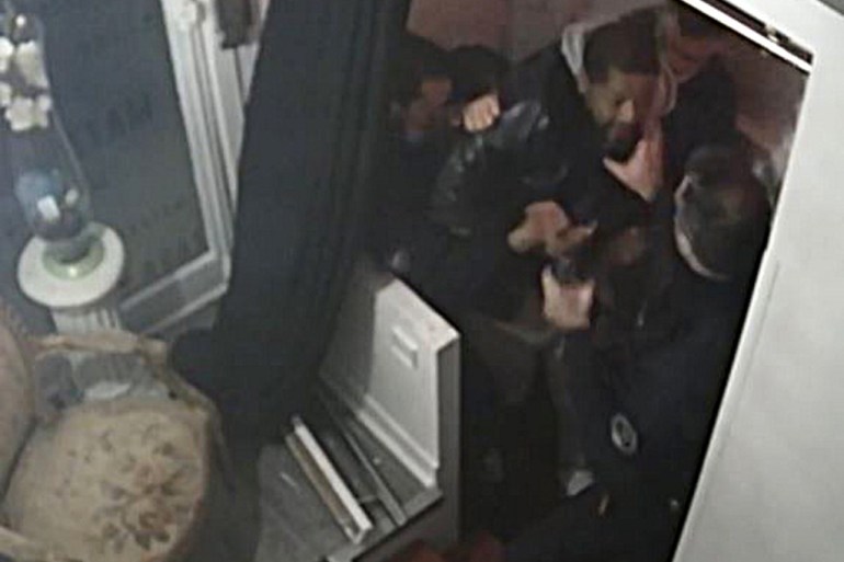 A CCTV camera footage shows producer Michel Zecler being beaten up by French police officers at the entrance of his music studio in Paris [Michel Zecler/GS Group via AFP]