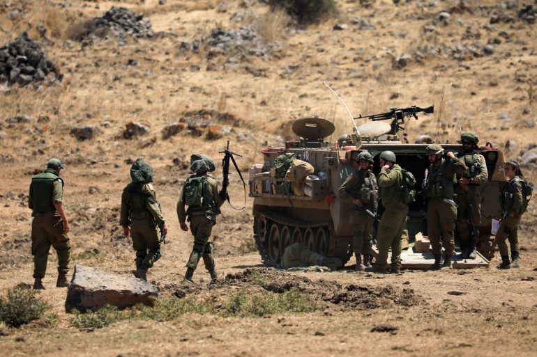 Israeli soldiers and a tank during a military drill