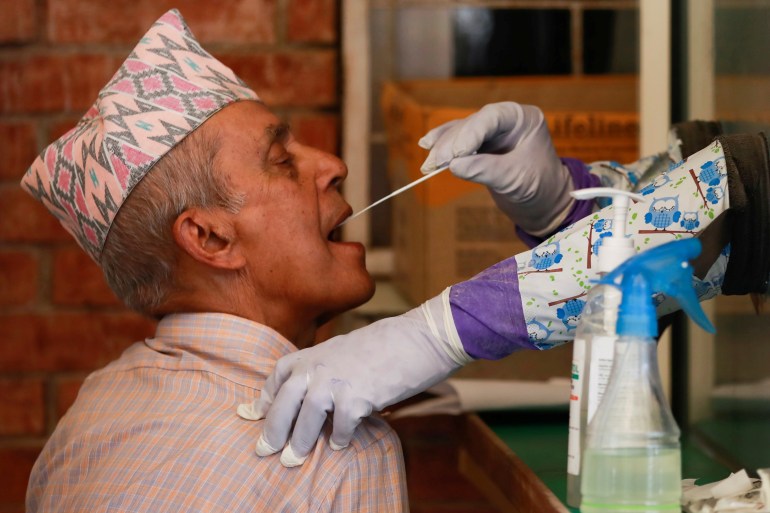 A man takes a polymerase chain reaction test for the coronavirus disease in Kathmandu [Navesh Chitrakar/Reuters]