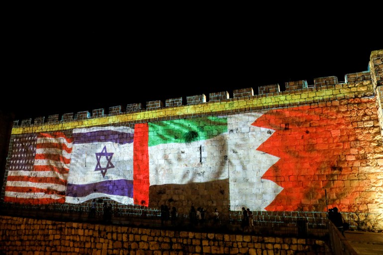 National flags of Bahrain, UAE, Israel and the US are projected on the walls of Jerusalem's Old City [File: L Ronen Zvulun/Reuters]