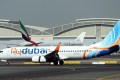 An aircraft (front) owned by 'Fly Dubai'