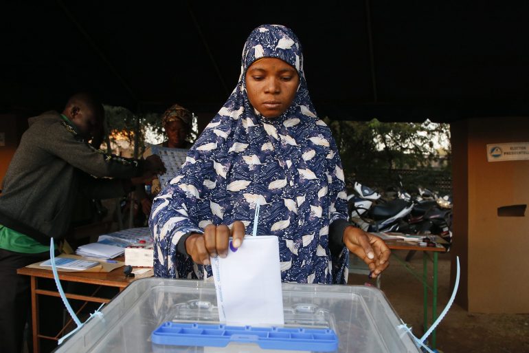 A woman casts her ballot at a polling station in Ouagadougou [Legnan Koula/EPA]