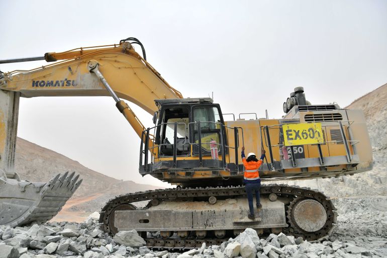 An excavator operator fiddles with the equipment at a gold mine in Burkina Faso. [File: Anne Mimault/Reuters]
