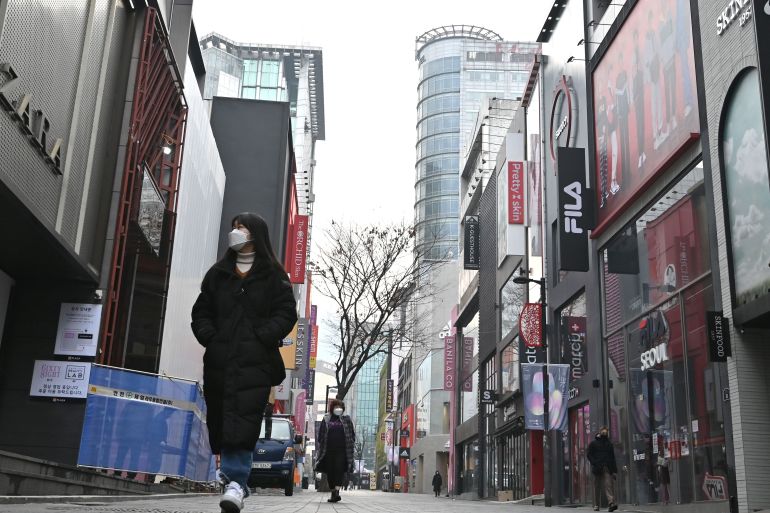 A woman walking on a street in Seoul, South Korea