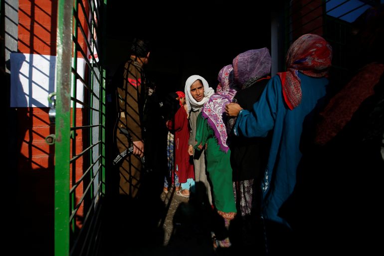 Women queue to vote at a polling station during thegeneral election in Khrew in south Kashmir