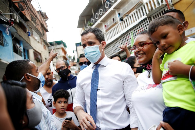 Venezuela's opposition leader Juan Guaido greets supporters in low-income neighborhood