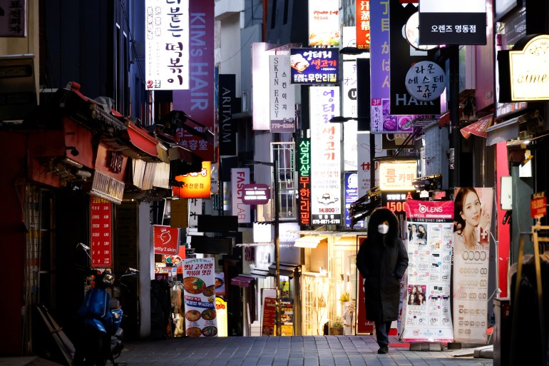 South Korean woman walks empty street during COVID