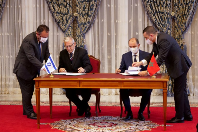 Unidentified Moroccan and Israeli officials sign memorandums of understanding