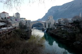 The Old Bridge in Mostar, one of Bosnia's best known landmarks, Bosnia, in Mostar, Bosnia, Sunday, Dec. 20, 2020. Divided between Muslim Bosniaks and Catholic Croats, who fought fiercely for control over the city during the 1990s conflict, Mostar has not held a local poll since 2008, when Bosnia's constitutional court declared its election rules to be discriminatory and ordered that they be changed.