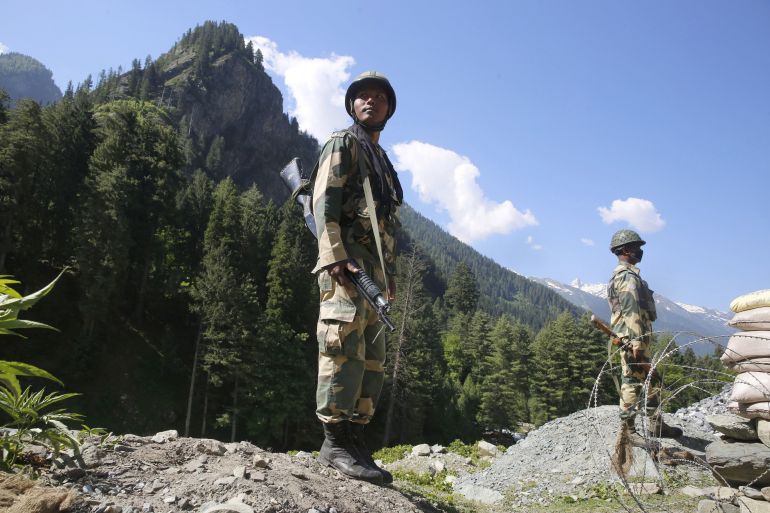 Indian paramilitary soldiers stand guard at check post along a highway leading to Ladakh, at Gagangeer some 81 kilometers from Srinagar [Farooq Khan/EPA]
