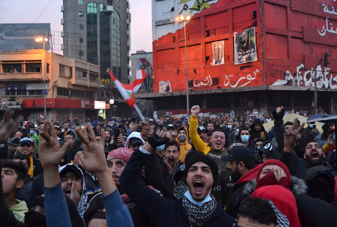 Lebanese protesters shout slogans as they gather at Al-Nour Square during continuing demonstrations in the northern port city of Tripoli. [Fathi al-Masri/AFP]