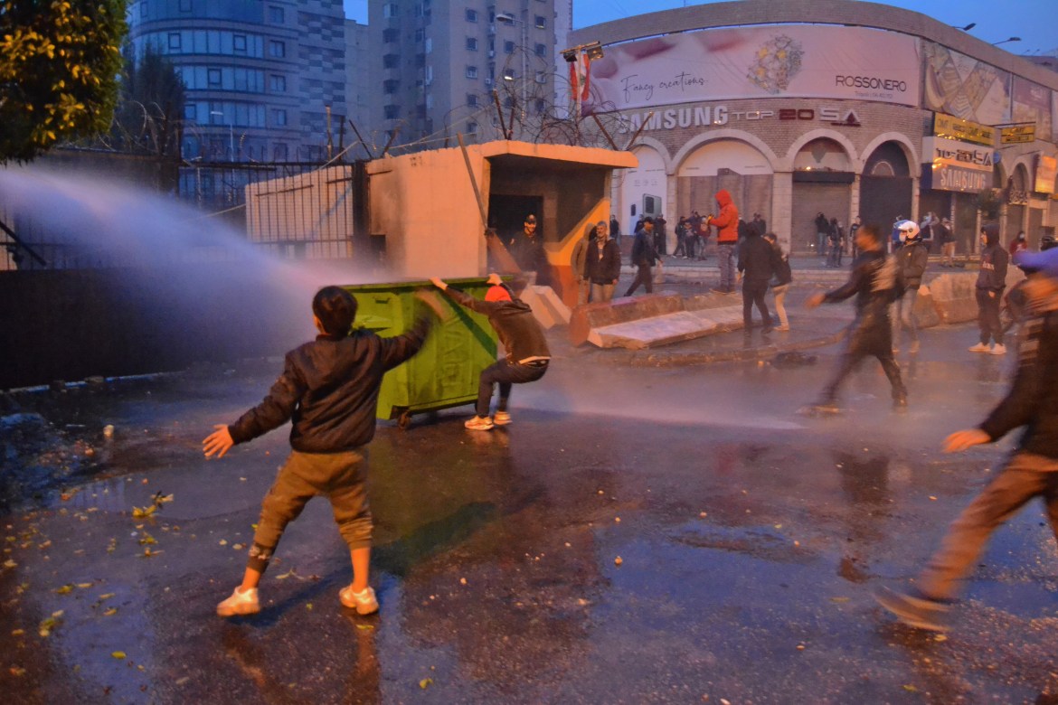 Lebanese security forces use water cannon to disperse protesters. [Fathi al-Masri/AFP]