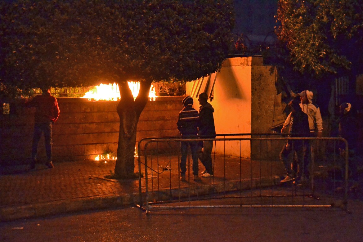 Protesters throw petrol bombs in the Serail. Protesters are angered by a coronavirus lockdown and severe economic crisis. [Fathi al-Masri/AFP]