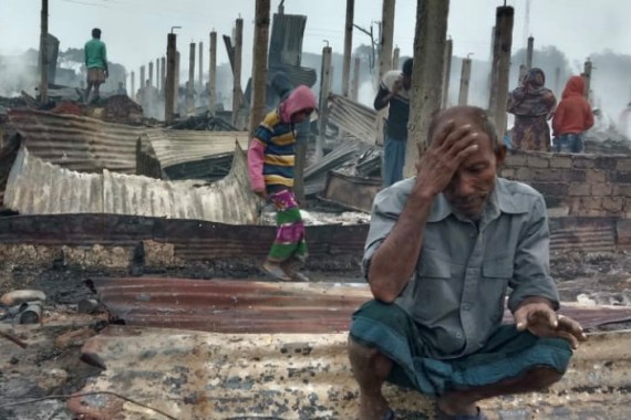 A Rohingya man reacts after a fire burned houses of the Nayapara refugee camp in Cox's Bazar, Bangladesh [Mohammed Arakani/Reuters]