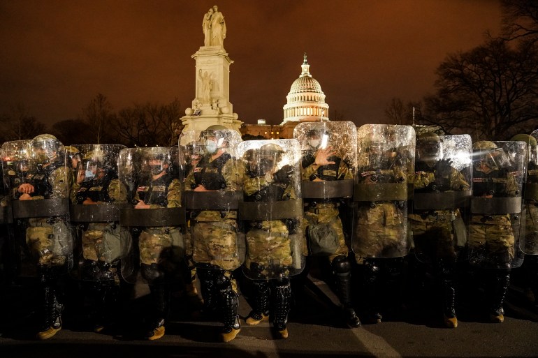 District of Columbia National Guard stand outside the Capitol, Wednesday night, Jan. 6, 2021, after a day of rioting protesters.