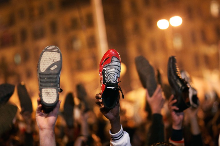  Anti-government protesters raise their shoes after a speech by Egyptian President Hosni Mubarek February 10, 2011 in Cairo, Egypt. President Hosni Mubarak made a statement saying that he had given some powers to his vice president but would not resign or leave the country, leaving a crowd of anti-government protesters disappointed and furious after early reports he might step down. (Photo by Chris Hondros/Getty Images)