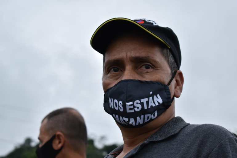 Ex FARC fighter in facemark that says they are killing us