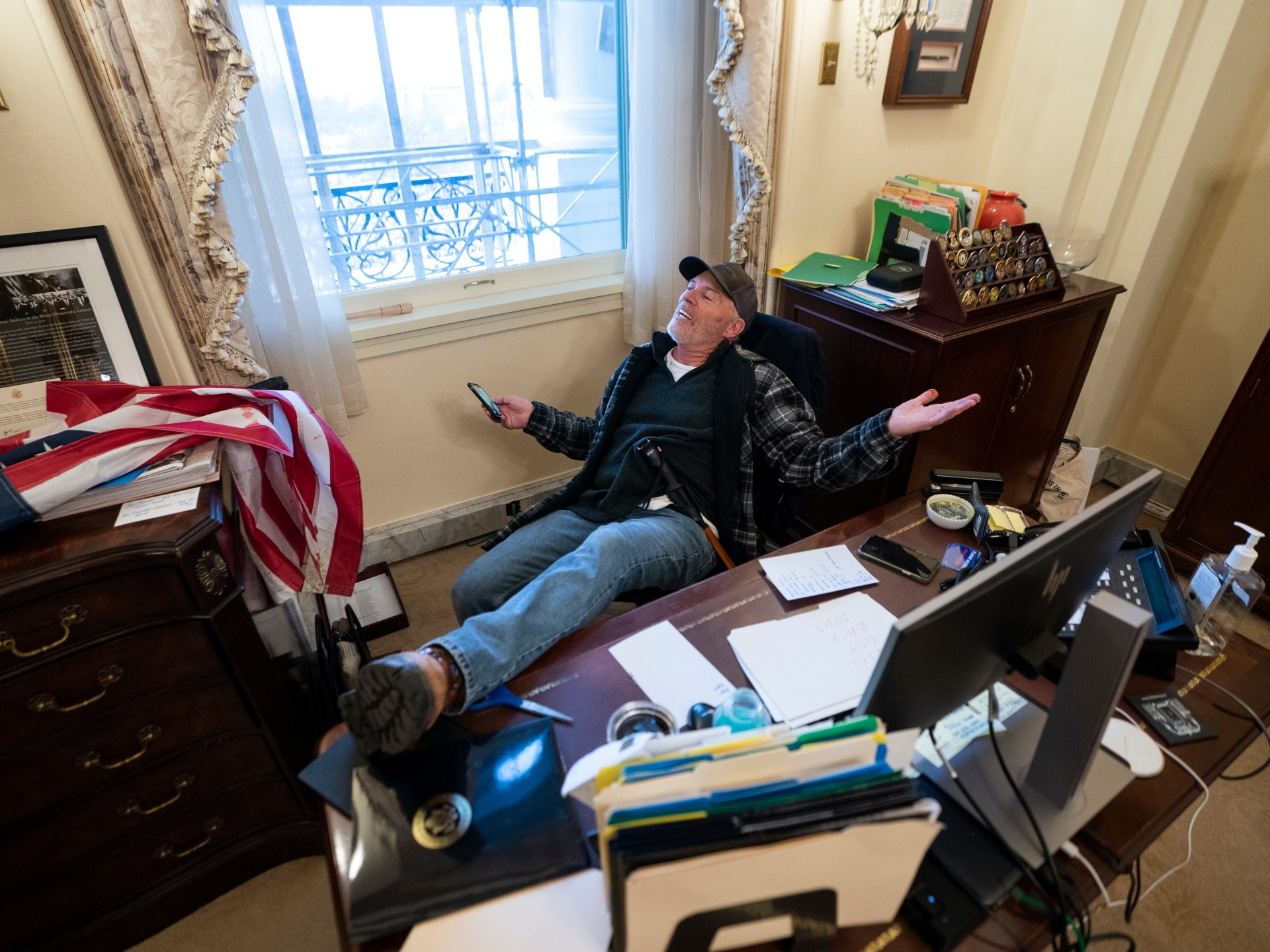 Man photographed with foot on Pelosi’s desk on Jan 6 found guilty