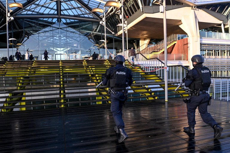 Heavily armed policemen patroll outside the courthouse during the trial of four persons including an Iranian diplomate and Belgian-Iranian couple before the Antwerp criminal court in Antwerp, on February 4, 2021. - A Belgian court returns a verdict on February 4, 2021, in the trial of an Iranian diplomat accused of plotting a bomb attack against opposition activists meeting in France. Assadollah Assadi, a 49-year-old formerly based in Vienna, faces up to 20 years in prison if convicted of plotting to target the June 30, 2018 rally. The gathering in Villepinte outside Paris included senior leaders of the exiled National Council of Resistance in Iran (NCRI) and some high-profile supporters.