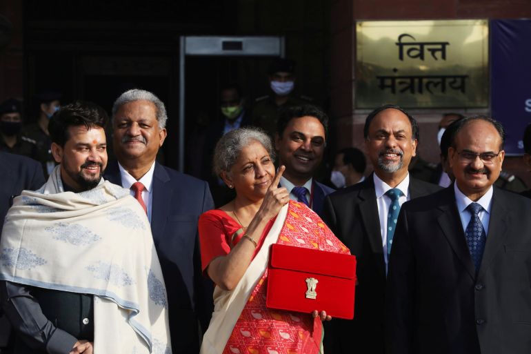 India's Finance Minister Nirmala Sitharaman stands next to Minister of State for Finance and Corporate Affairs Anurag Thakur as she leaves her office to present the federal budget in the parliament in New Delhi, India