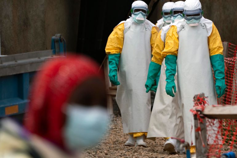Health workers dressed in protective gear at an Ebola treatment centre in Beni [File: Jerome Delay/AP Photo]