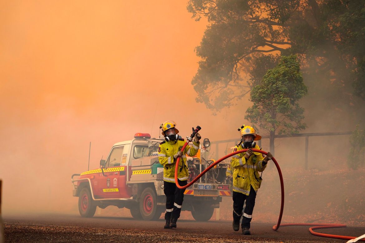 Firefighters attend to a fire near Wooroloo, northeast of Perth, Australia, Tuesday, Feb. 2, 2021.