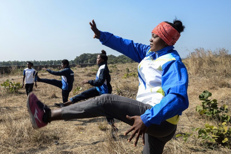 Shahnaz Lobi, right, along with other members of Siddi community join an exercise routine during an athletes programme at Jambur village in Junagadh district of Gujarat [Sam Panthaky/AFP]