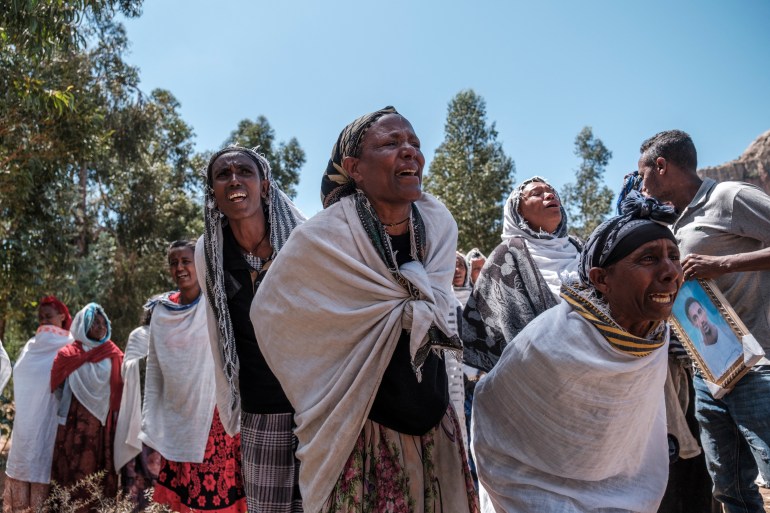 People mourn the victims of a massacre allegedly perpetrated by Eritrean soldiers in the village of Dengolat, north of Mekelle [Eduardo Soteras/AFP]