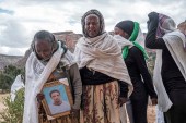 People gather to mourn the victims of a massacre allegedly perpetrated by Eritrean soldiers in the village of Dengolat in the Tigray region of Ethiopia on February 26, 2021 [File: AFP/Eduardo Soteras]