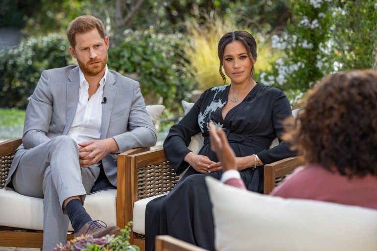 Prince Harry and his wife Meghan Markle in a conversation with US television host Oprah Winfrey. The couple's interview with Winfrey was broadcast late on Sunday in the US [Joe Pugliese/Harpo Productions via AFP]