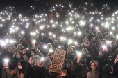 Well-wishers turn on their phone torches as they gather at a band-stand where a planned vigil in honour of murder victim Sarah Everard was cancelled after police outlawed it due to COVID-19 restrictions, on Clapham Common, south London on March 13, 2021 [Justin Tallis/AFP]